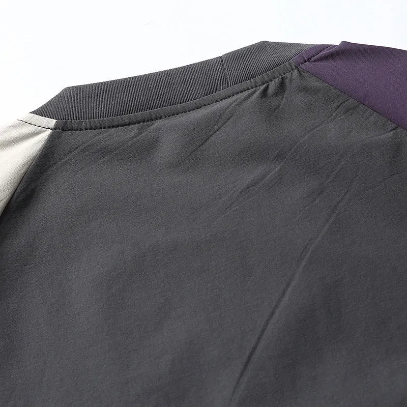 Dark grey men's t-shirt with contrast colour panels and raglan sleeves laid flat.