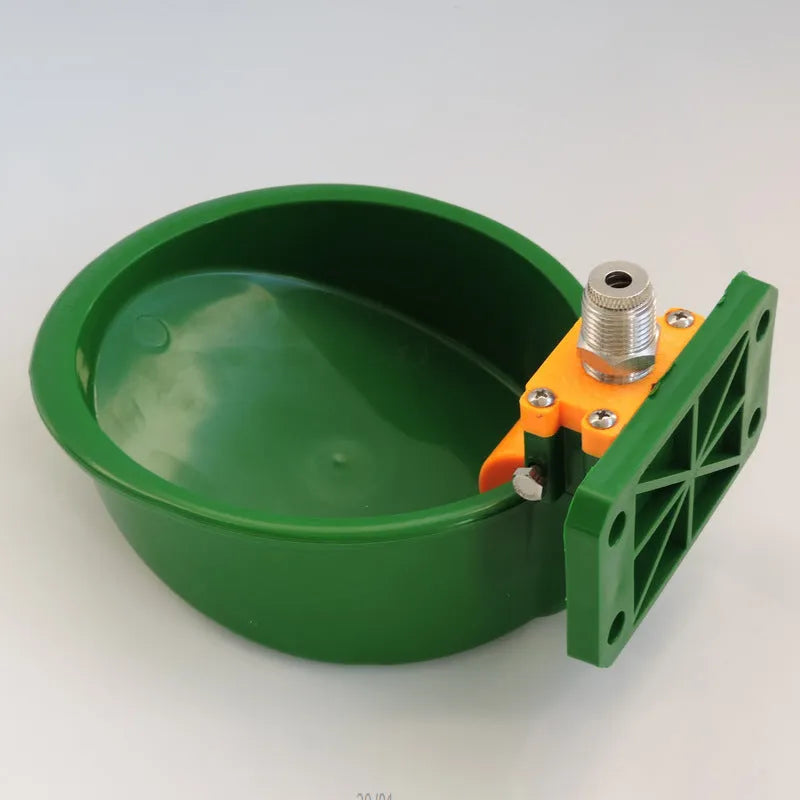 Green plastic automatic drinking bowl for sheep and pigs on farms