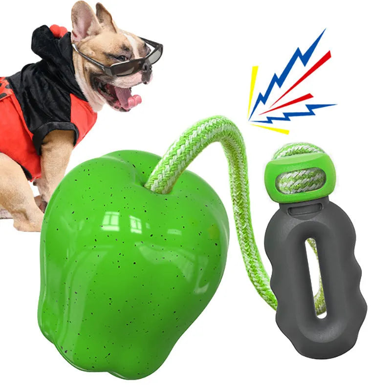 Green and red apple-shaped plastic dog toy with a textured surface and hollow centre.
