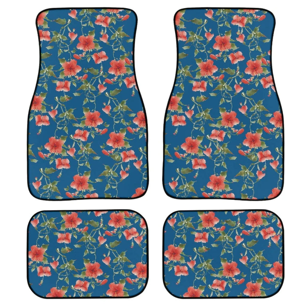 Set of four black rubber car floor mats with a textured surface and raised edges, shown in a vehicle footwell.