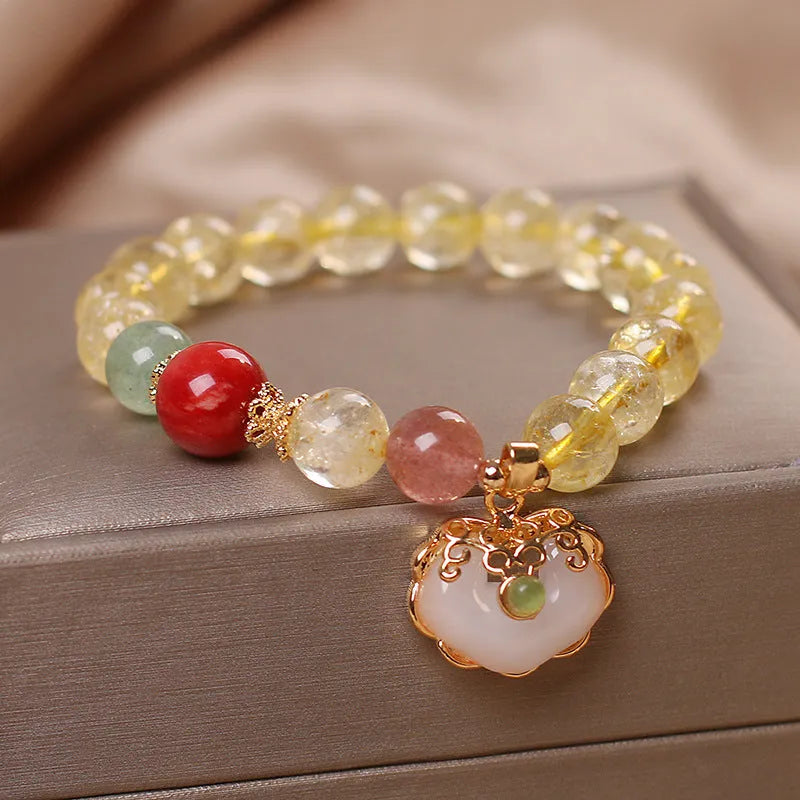 Women's adjustable alloy bracelet with a detailed natural citrine jade ruyi pendant in yellow tones.