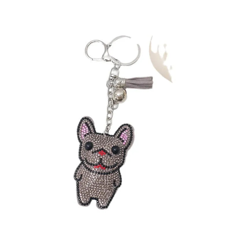 Close-up of a caramel-coloured alloy dog keychain with sparkling clear rhinestones.