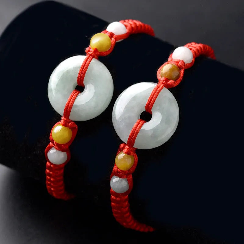 Burmese jade round pendant on an adjustable red rope bracelet with certificate.