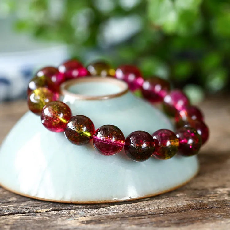 Close-up of a handmade pastel pink and green watermelon crystal bracelet for women, showing bead detail.