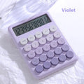 Gradient colour desktop calculator in violet, pink, blue, and green shades on a desk.