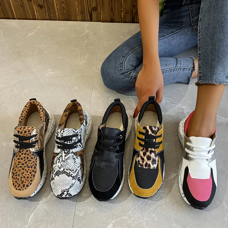 Women's casual suede wedge sneakers in leopard print with a low-cut design and plastic sole.