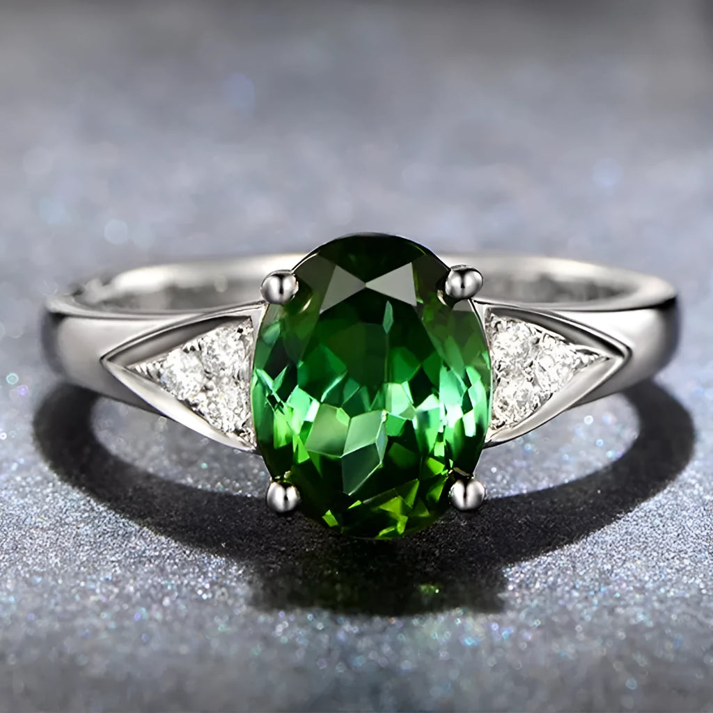 Close-up of a women's court-style silver-toned ring with an inlaid red natural zircon stone cut in a heart shape.