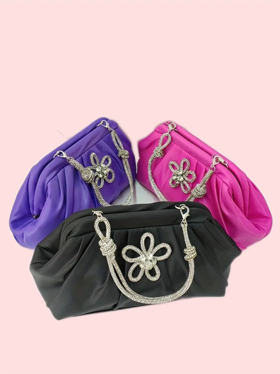 Soft shell-shaped lavender purple women's shoulder bag with fold, diamond, and chain details.