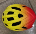 Orange mountain bike helmet with multiple vents shown on a white background.