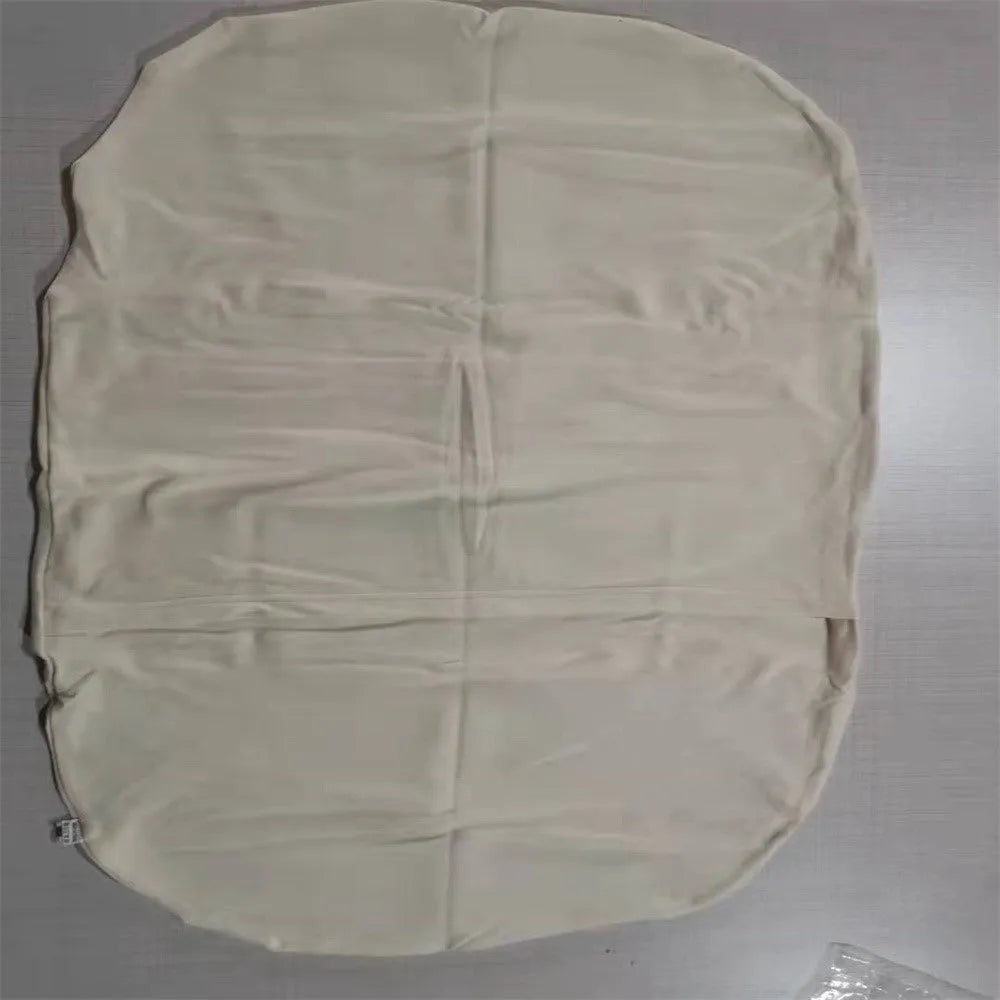 Beige portable baby nest cot crib for infants on a neutral background