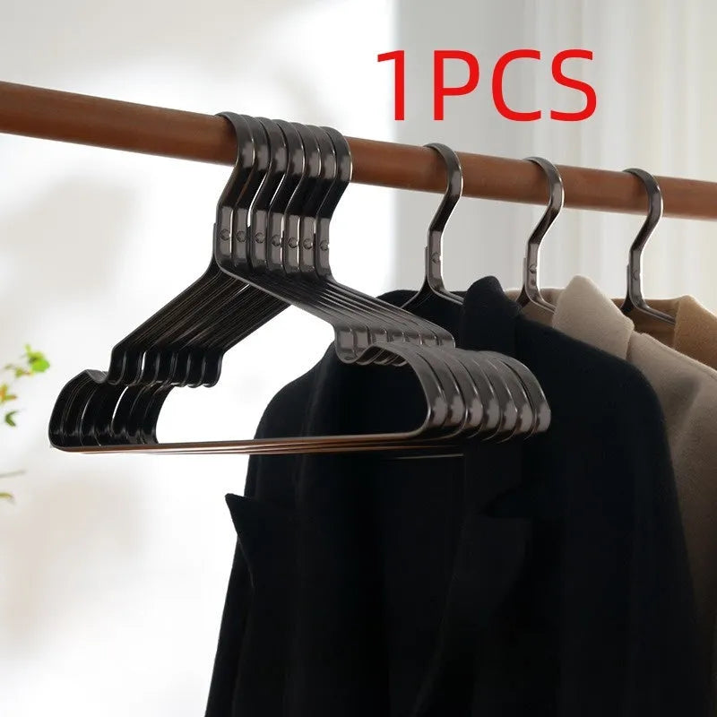 Elegant black non-slip metal clothes hanger for suits and trousers.
