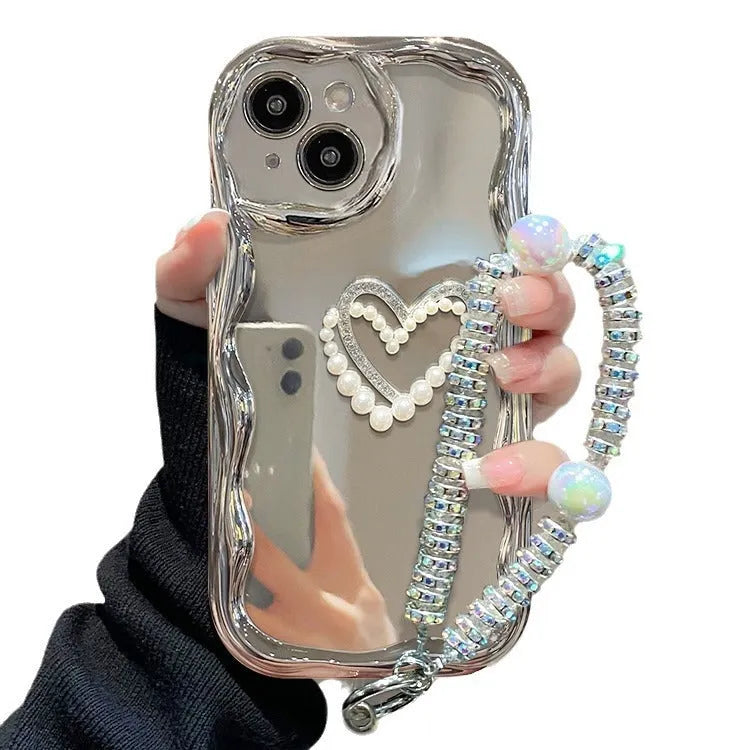 Silver grey silicone phone case for iPhone 14 Pro Max with three-dimensional heart and pearl chain bracelet.