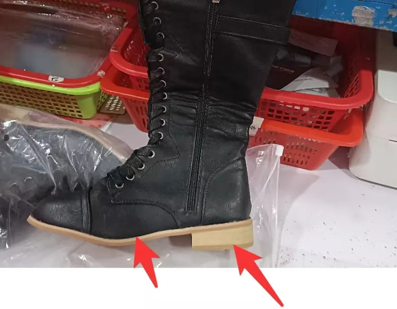 Women's black knight ankle boots with a cross strap detail over the front, made from artificial PU.