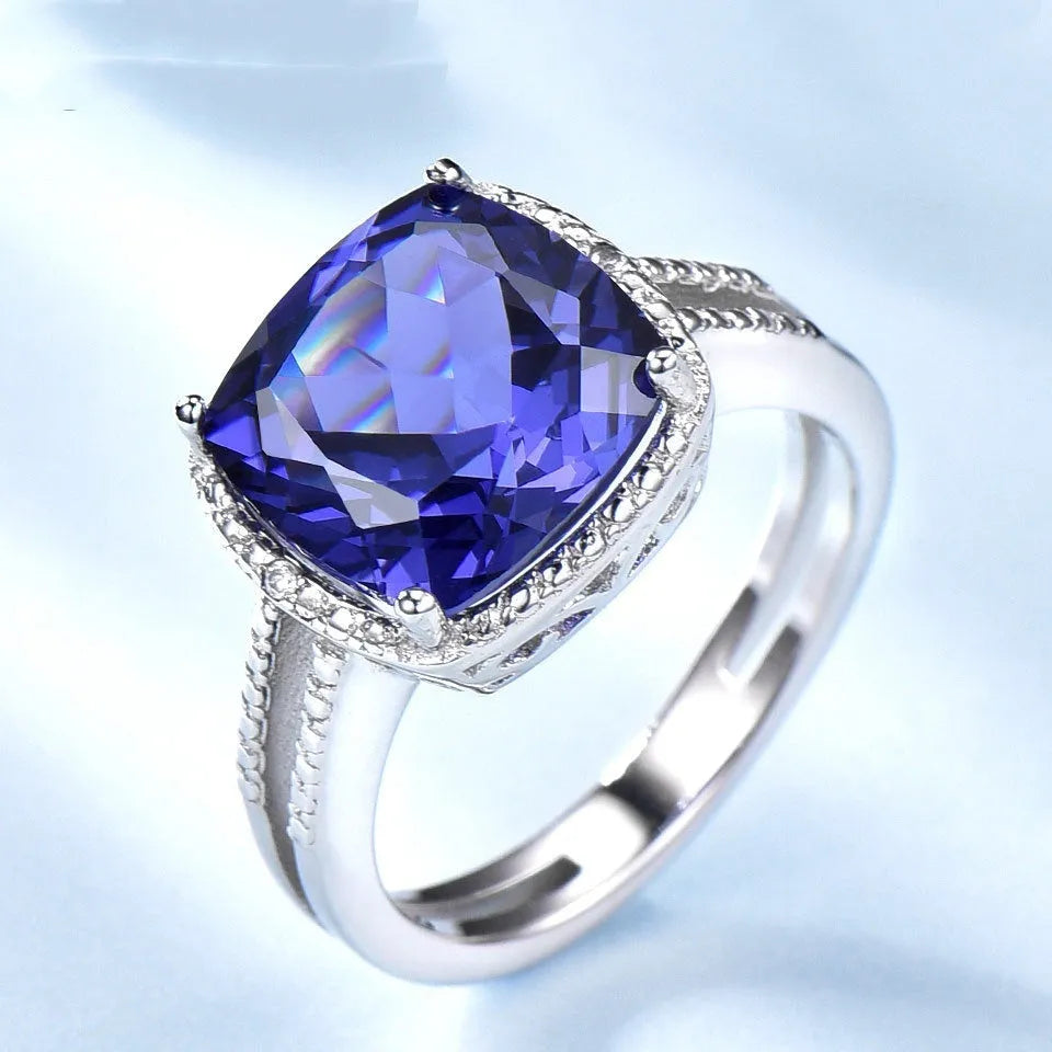 Close-up of a women's sterling silver ring with a blue tanzanite gemstone.