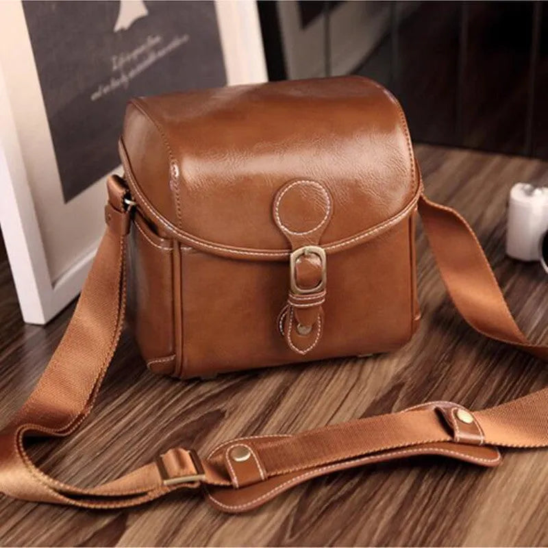 Single shoulder SLR camera liner bag in PU leather with polyester cotton insert, shown in reddish brown