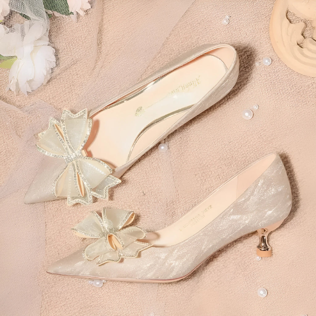 Women's champagne gold sequined pointed stiletto heel pumps for weddings, shown on a plain background.