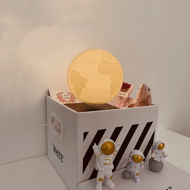 Maglev floating LED night light with planet design and three astronaut figures on display