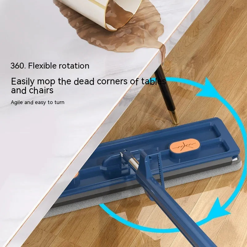 Large blue flat mop with a long stainless steel handle and a rotating head on a wooden floor.