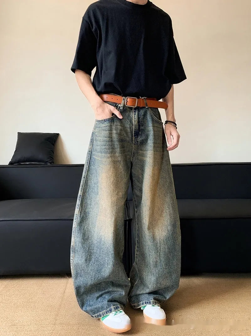 Man wearing Retro Blue distressed wide-leg denim jeans with a slimming silhouette and mid-waist fit.