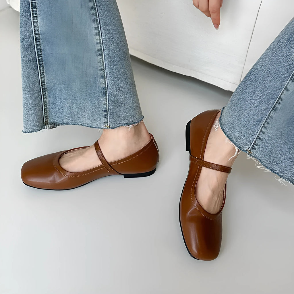 Retro brown Mary Jane flat shoes with a round toe and a single strap, showing the sheepskin upper.