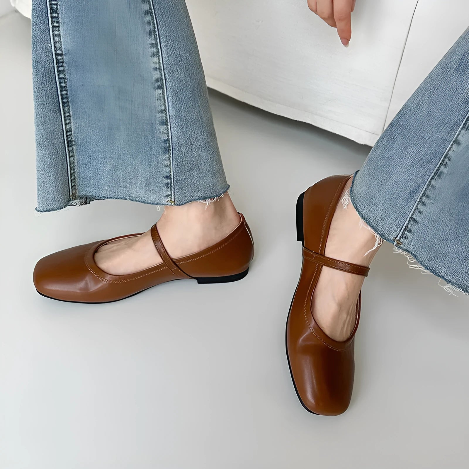 Retro brown Mary Jane flat shoes with a round toe and a single strap, showing the sheepskin upper.