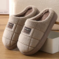 Men's grey and brown plaid winter slippers with a thick sole and rabbit hair trim.