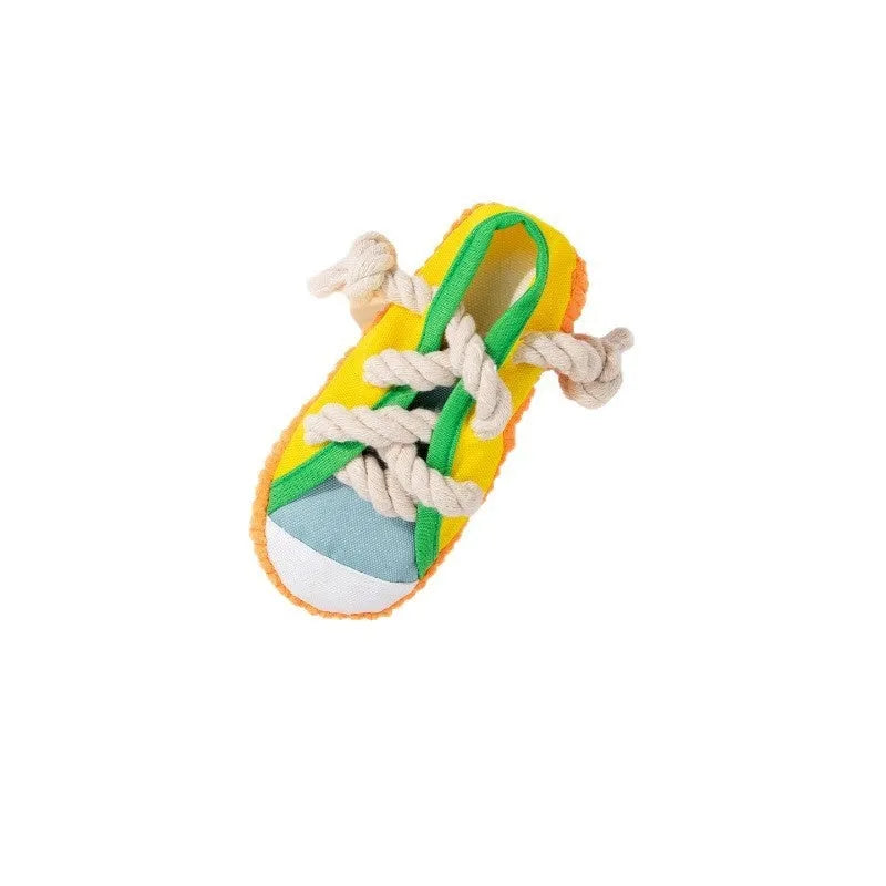 Yellow plastic dog slippers chew toy with a squeaker on a white background.