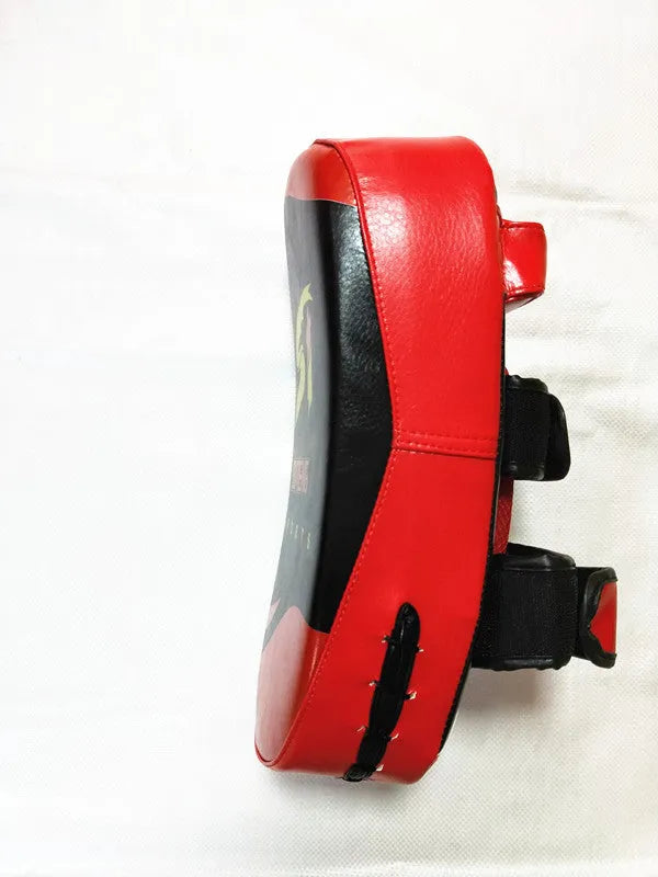 Black and red square hand-held martial arts training target pad with a buckle strap.