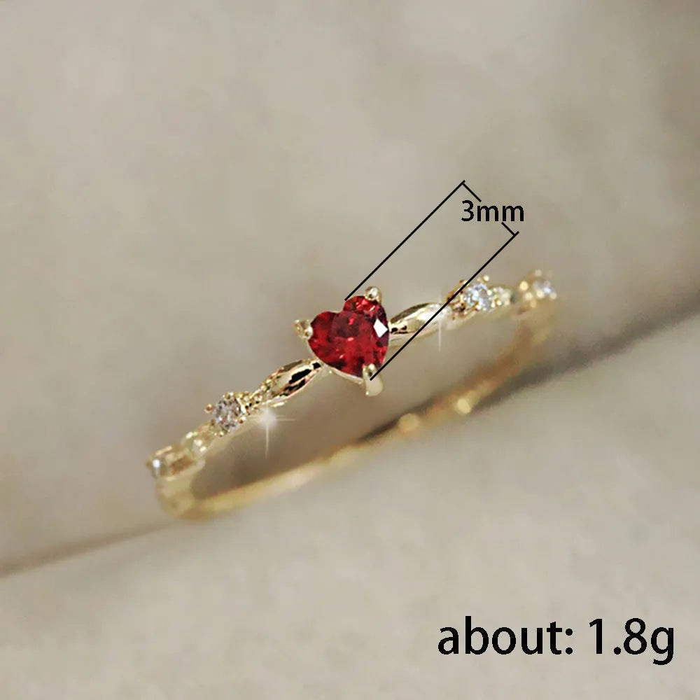 Personalised gold or silver plated ring with a peach heart charm and clear zircon stones.