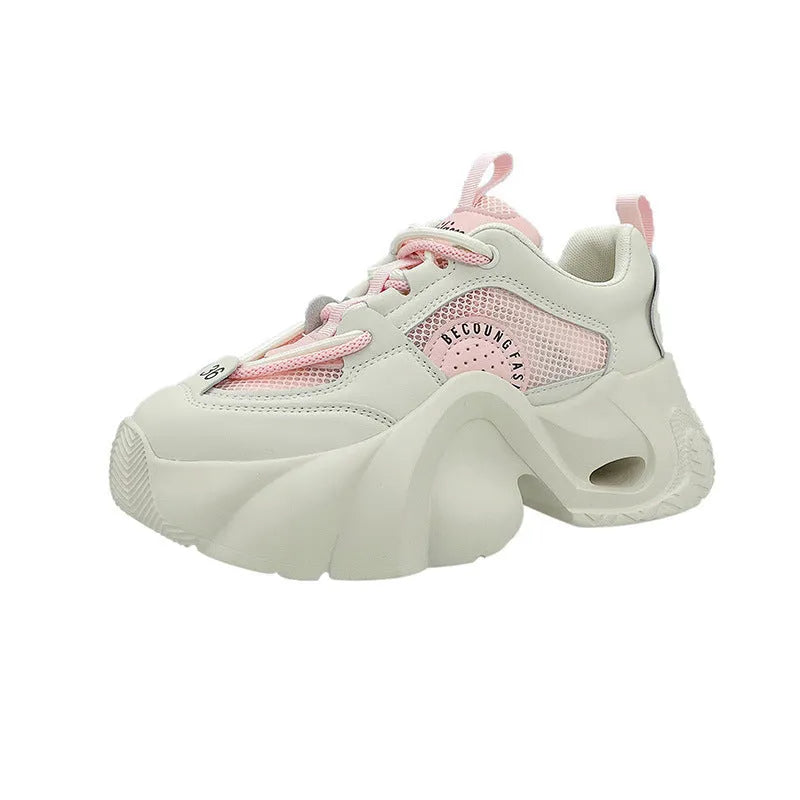Women's pink casual sneakers with thick sole, cross straps, and mesh lining.
