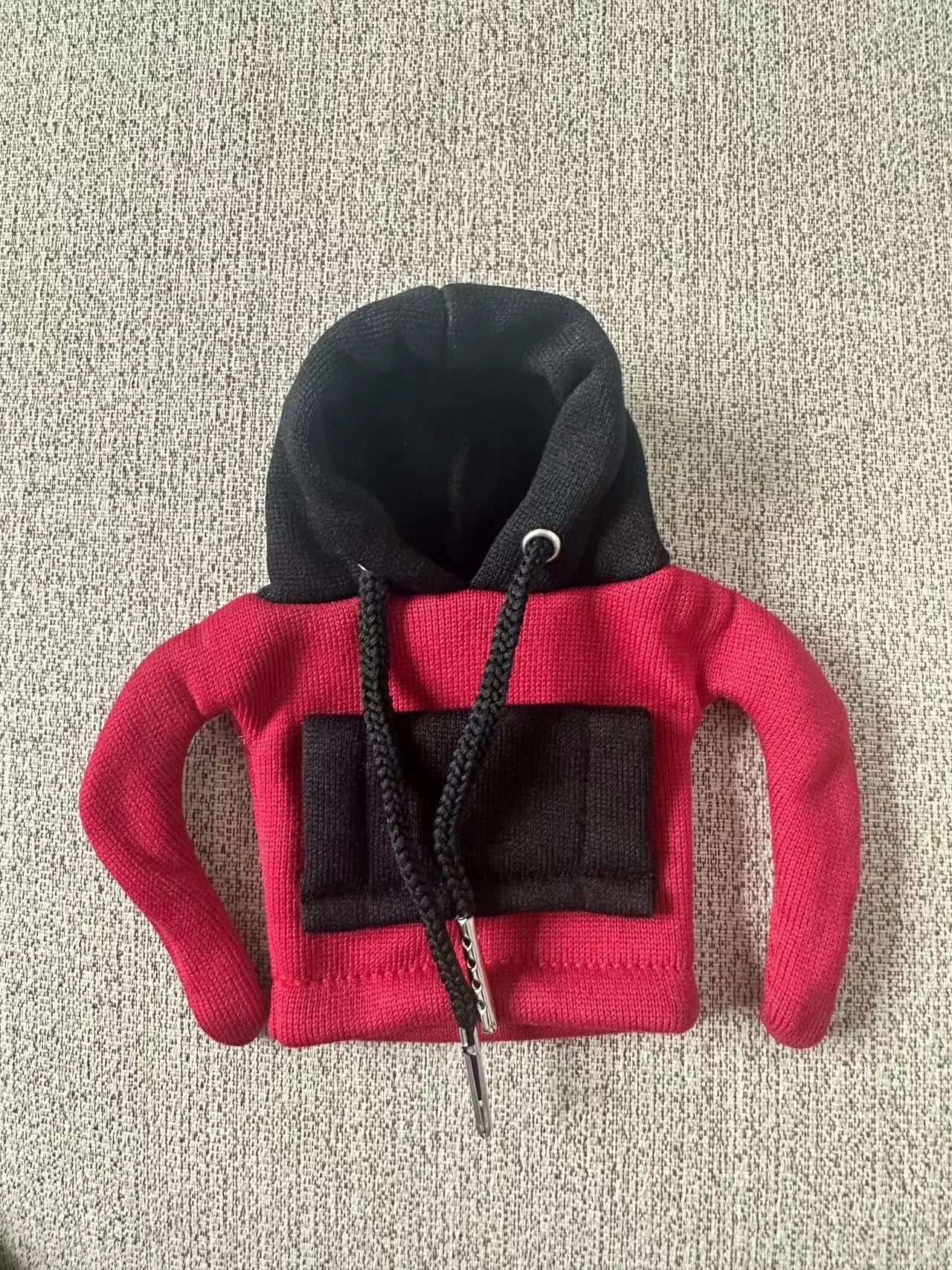 Red and white polyester car gear lever hood cover on a black gear stick.