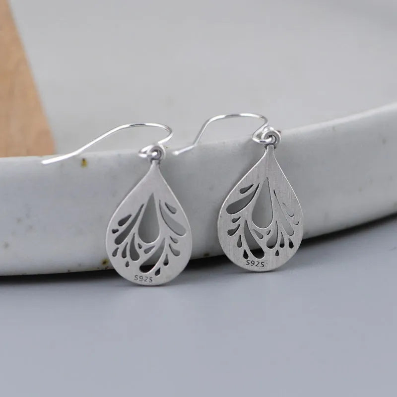 925 sterling silver hollow water drop retro earrings for women, showing grinding texture.