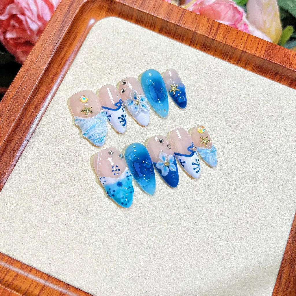 Set of hand-painted blue plastic fake nails with carved Summer Ice design in four sizes XS S M L