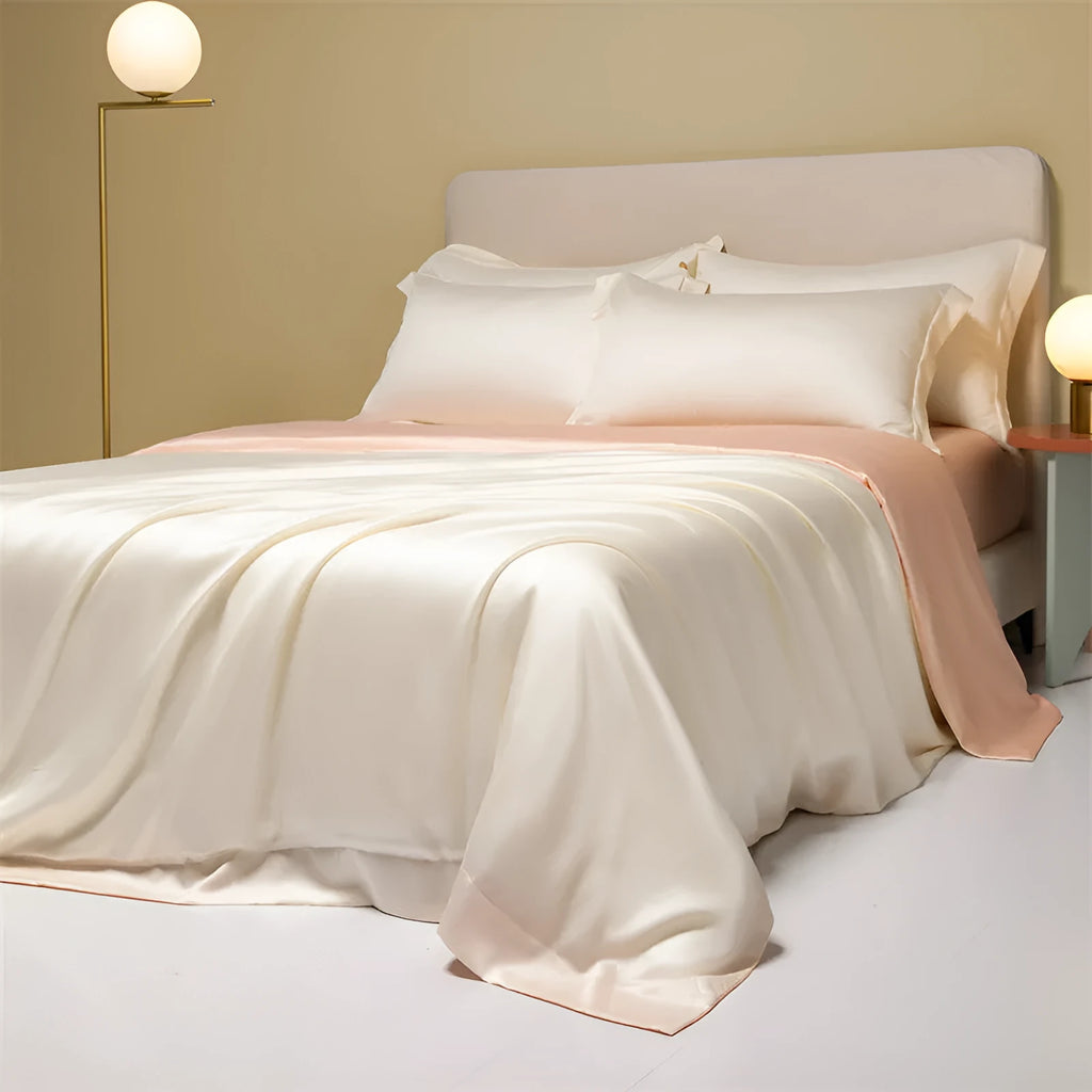 Luxury Lenzing Tencel bedding set in Aurora Blue on a bed, showing quilt cover, sheet, and two pillowcases.