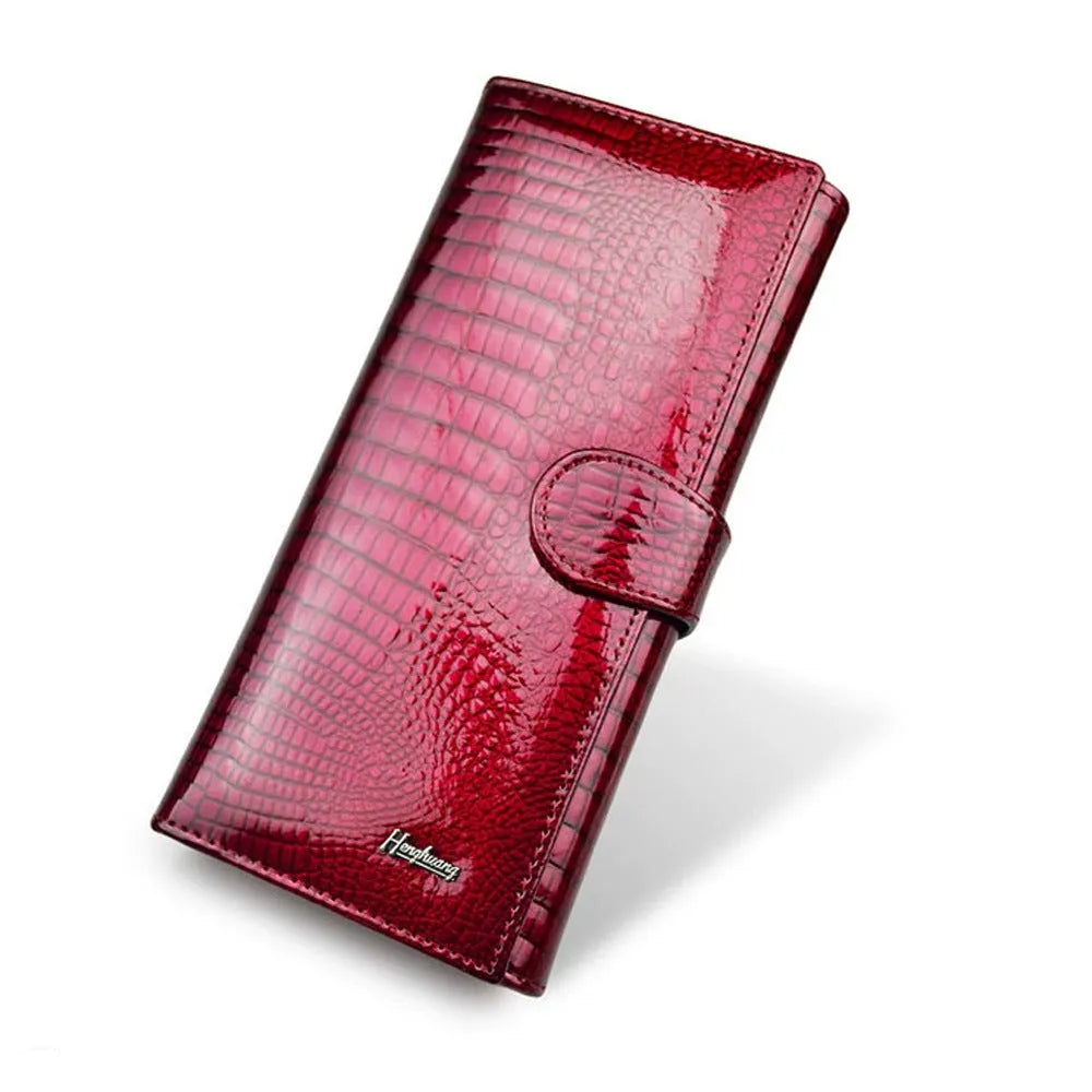 Red women's leather coin purse with a crocodile pattern texture and pigskin lining.