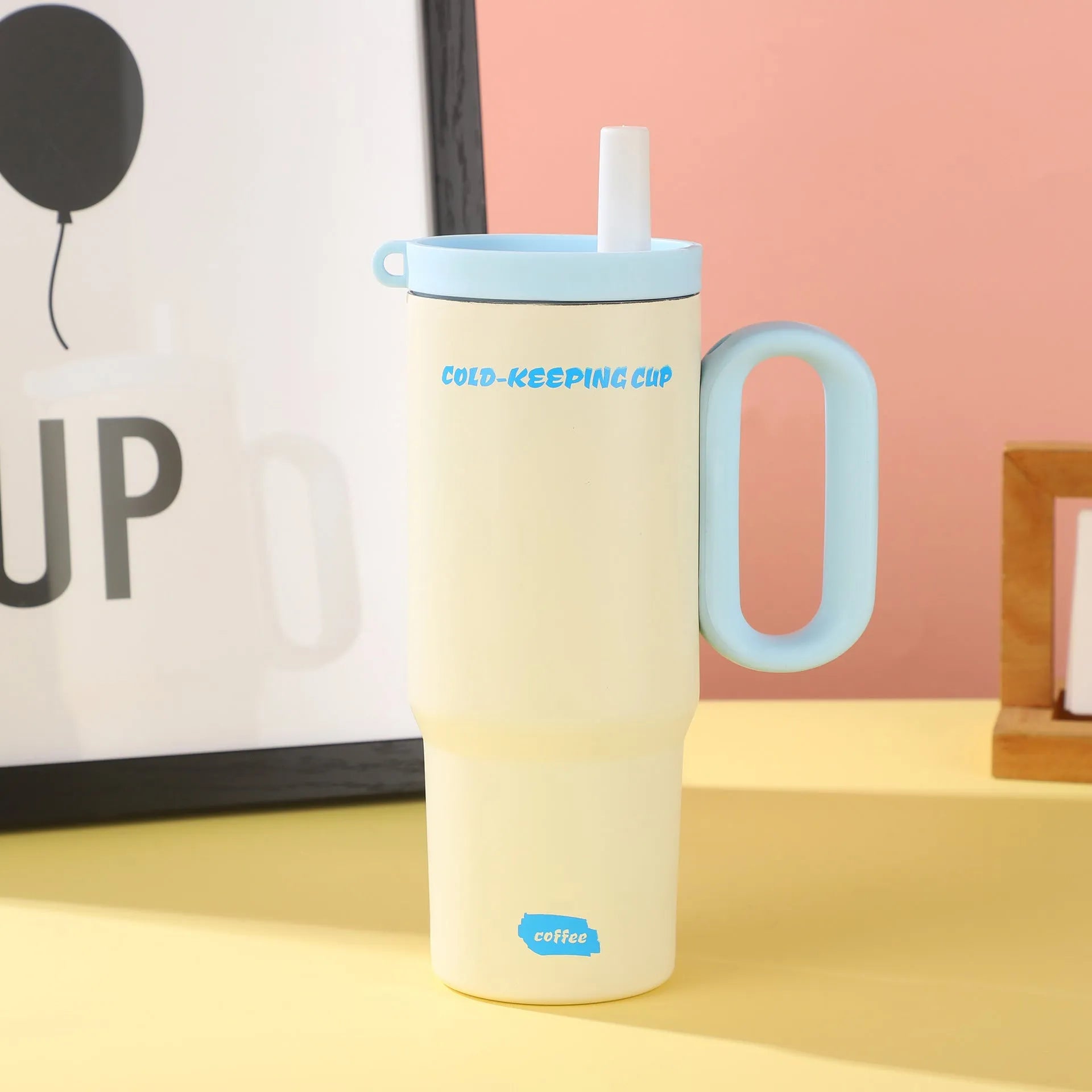 A large insulated portable cup with a handle, shown in multiple colour options.