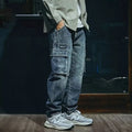 Men's loose straight-leg blue stretch denim jeans with a zip fly, shown on a hanger.