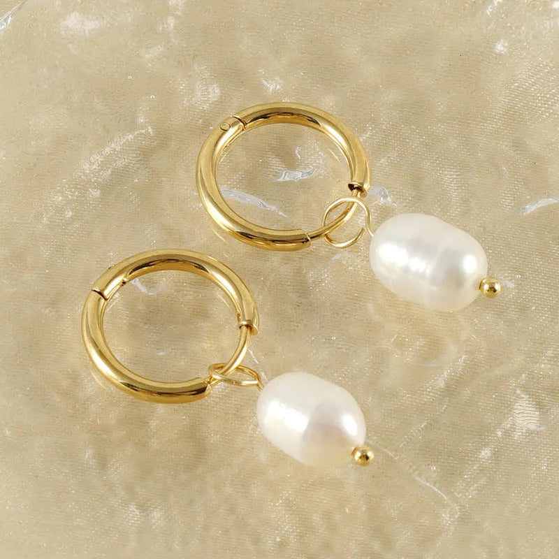 A pair of gold geometric earrings for women with pearl accents, made from stainless steel.