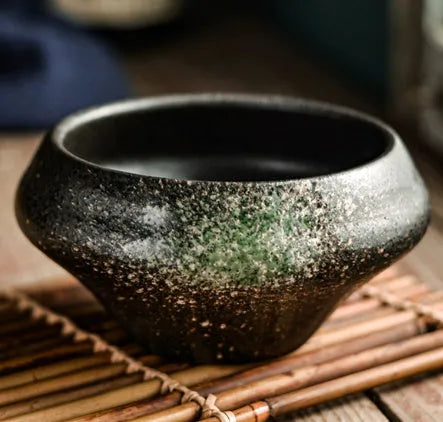 Tall porcelain ceramic Japanese soup bowl with underglaze vintage pattern on wooden table.