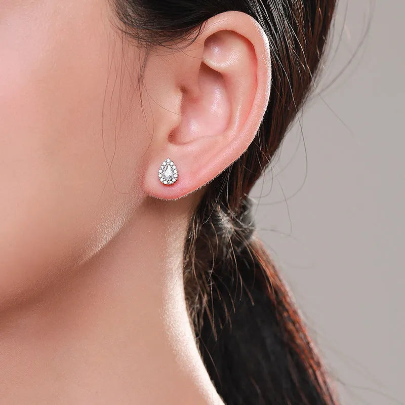 A pair of women's silver drop ear studs made from 925 sterling silver with a teardrop shape.