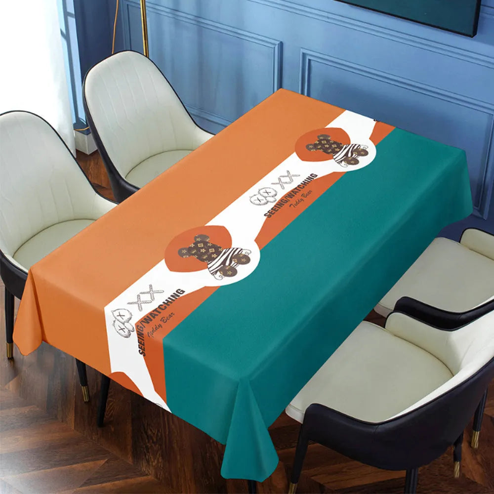 Rectangular PVC tablecloth on a coffee table, showing a geometric pattern and non-slip backing.