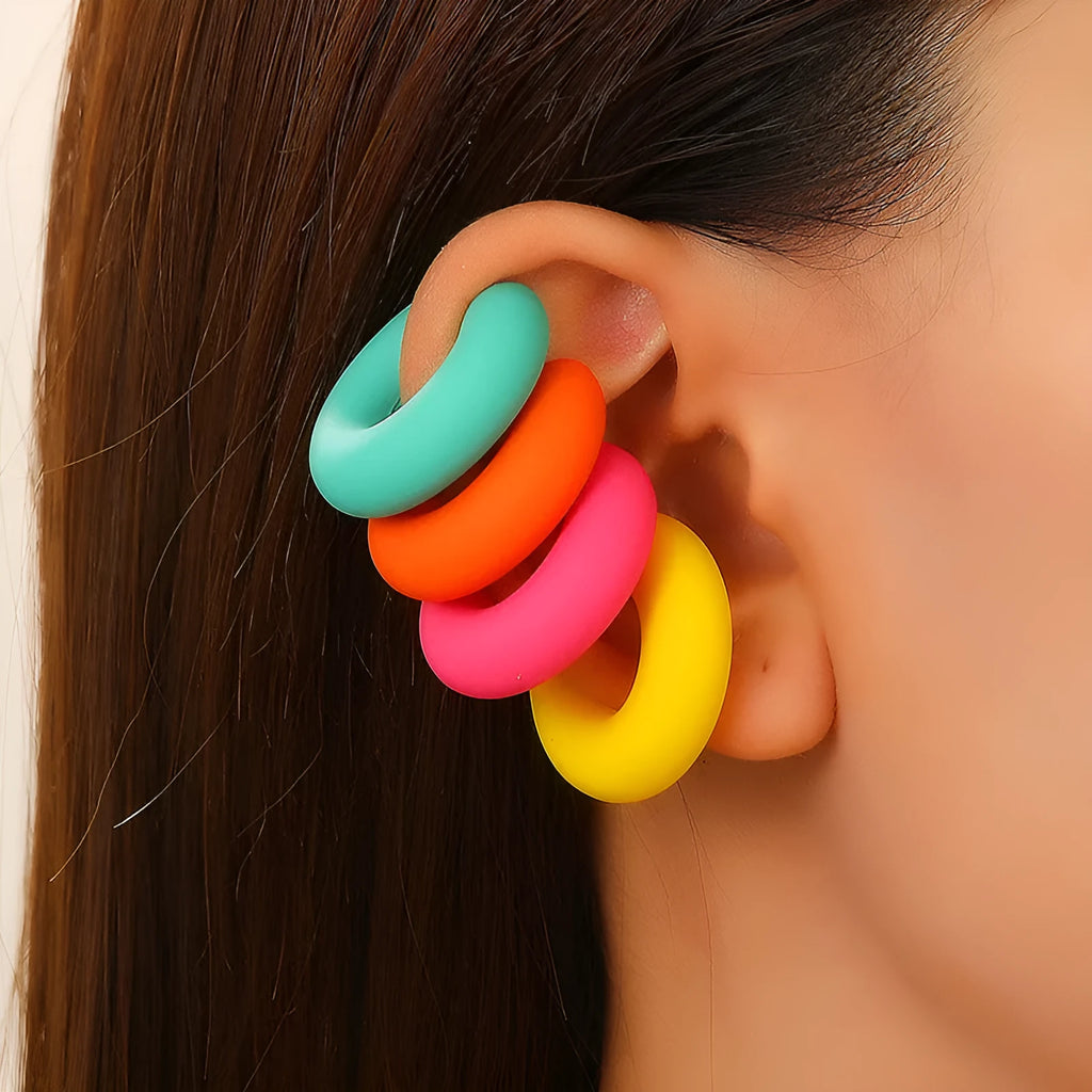Close-up of a pair of matte coarse round C-shaped clip-on earrings for women in a candy colour.