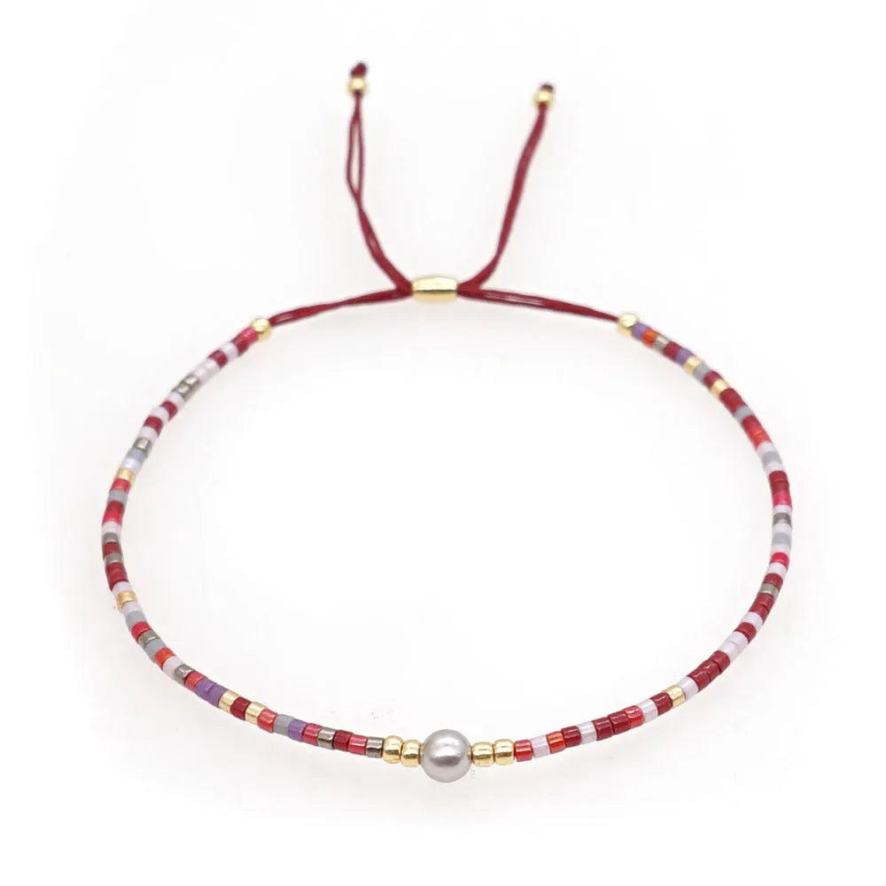 Handmade women's colourful beaded bracelet with geometric glass beads in bohemian style
