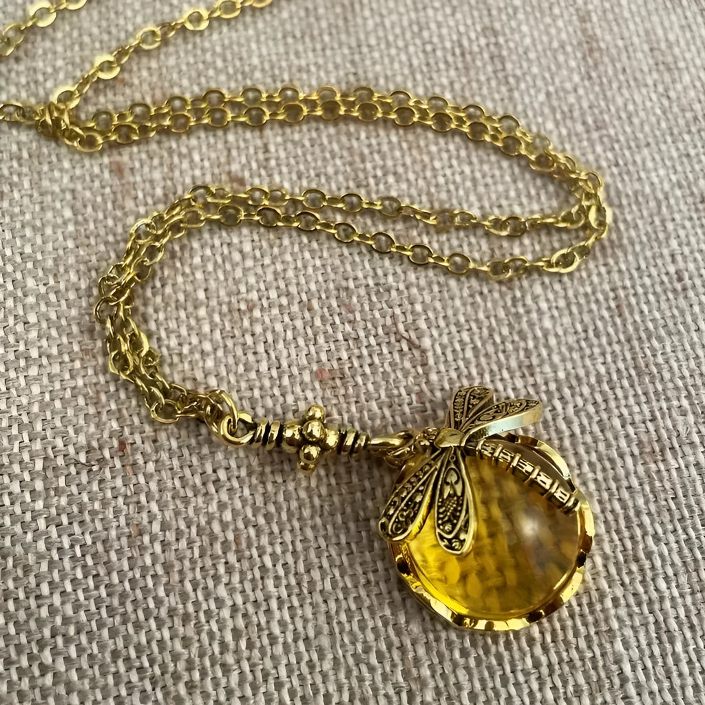 Yellow vintage bronze dragonfly pendant necklace on silver chain