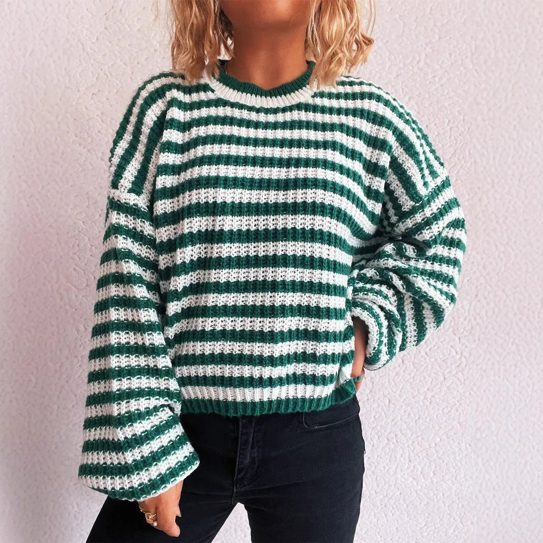 Women's loose vintage stripe knit pullover sweater in black on a hanger.