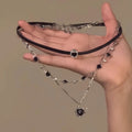 Women's twin necklace set with leather heart pendants on an adjustable alloy clavicle chain.