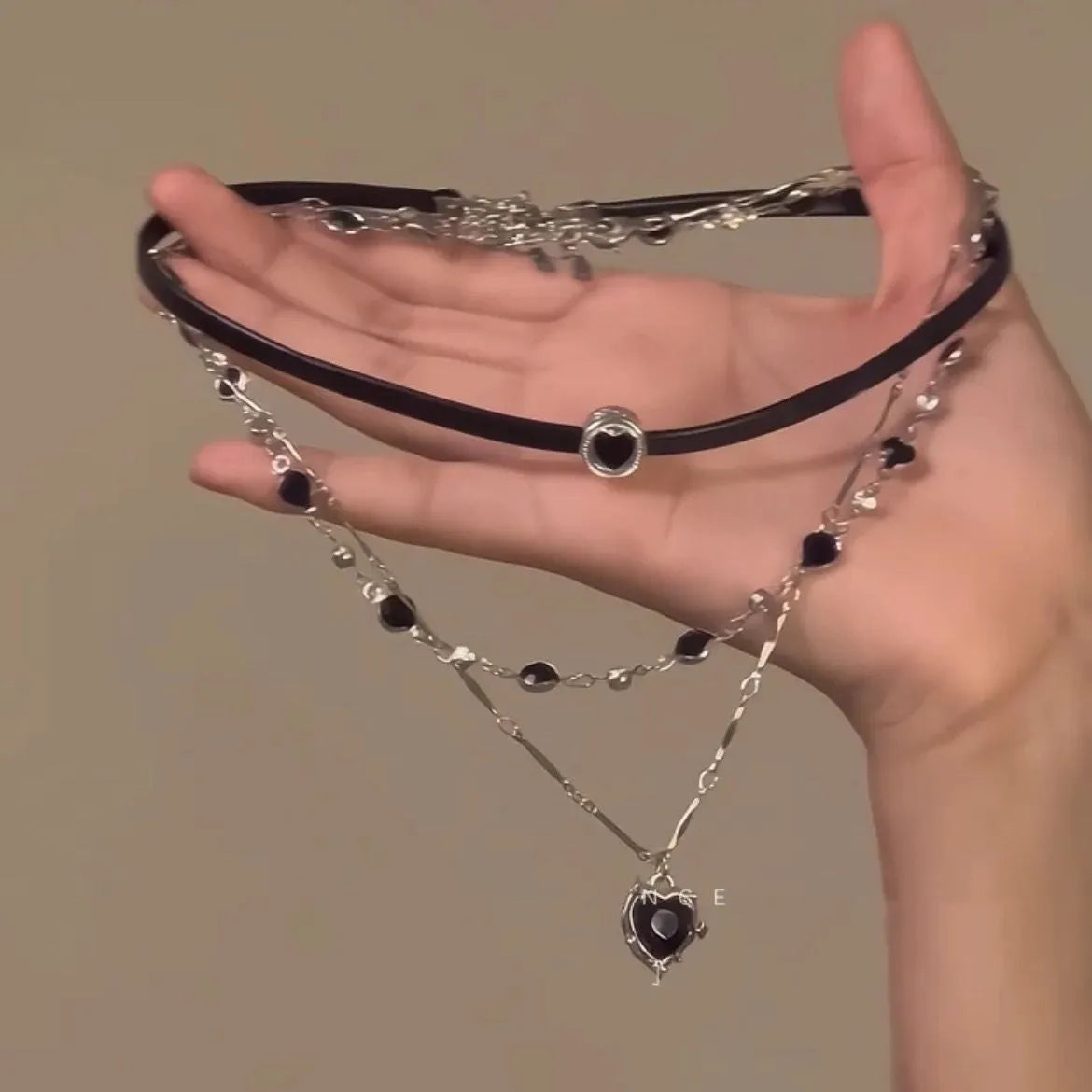 Women's twin necklace set with leather heart pendants on an adjustable alloy clavicle chain.