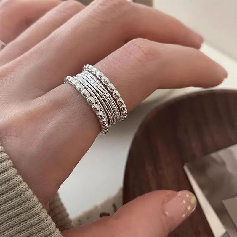 Adjustable geometric ring with woven twisted copper alloy construction