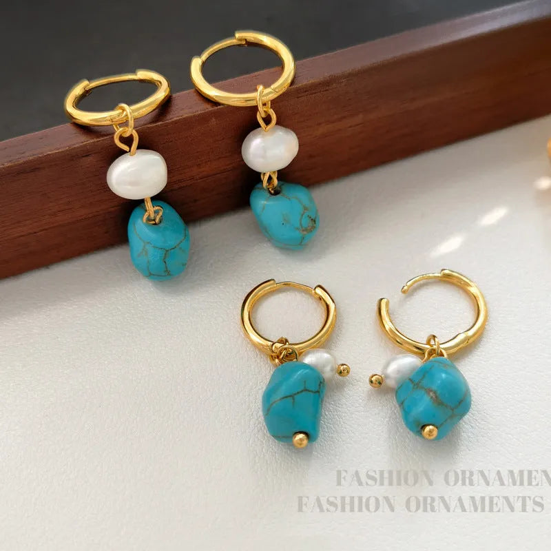 A set of two pairs of women's ear clips: one short and one dangle style, with geometric copper design, turquoise, and cultured pearls.