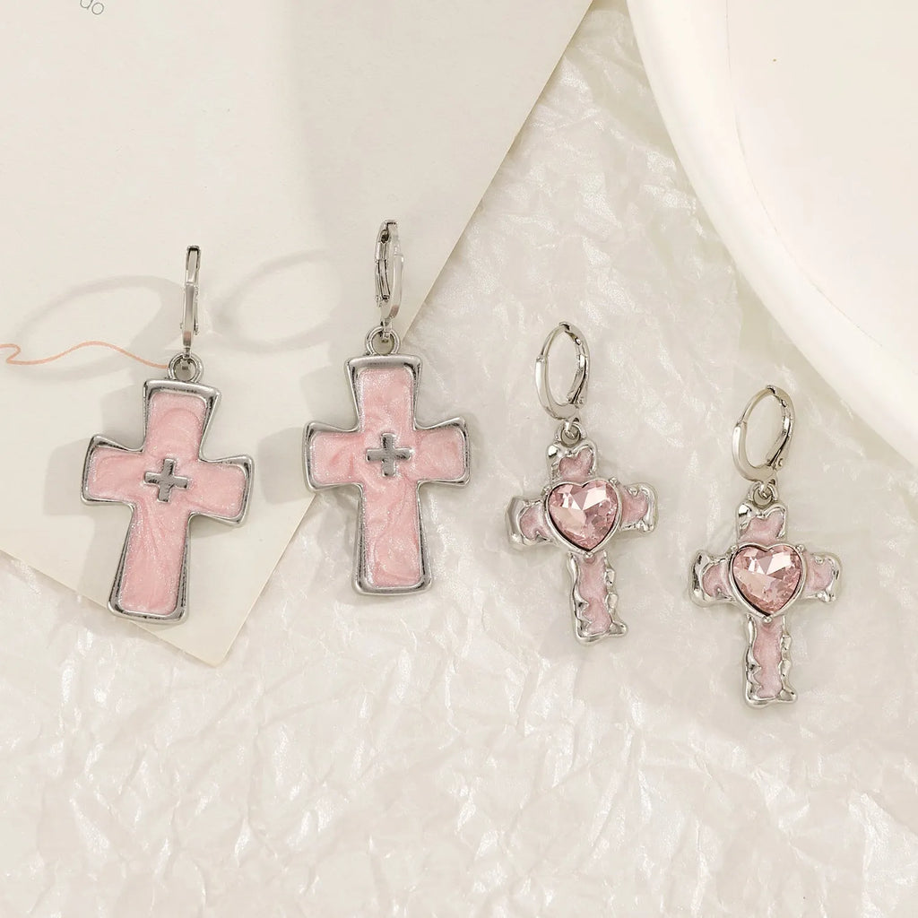Women's classic alloy earrings with cross crystal design in five colour options on display